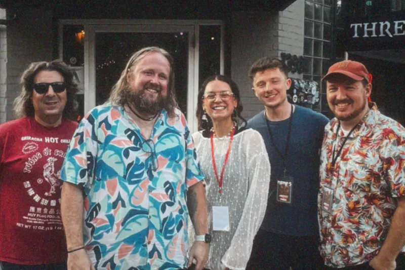 The five members of Future Ghosts standing together outside a venue
